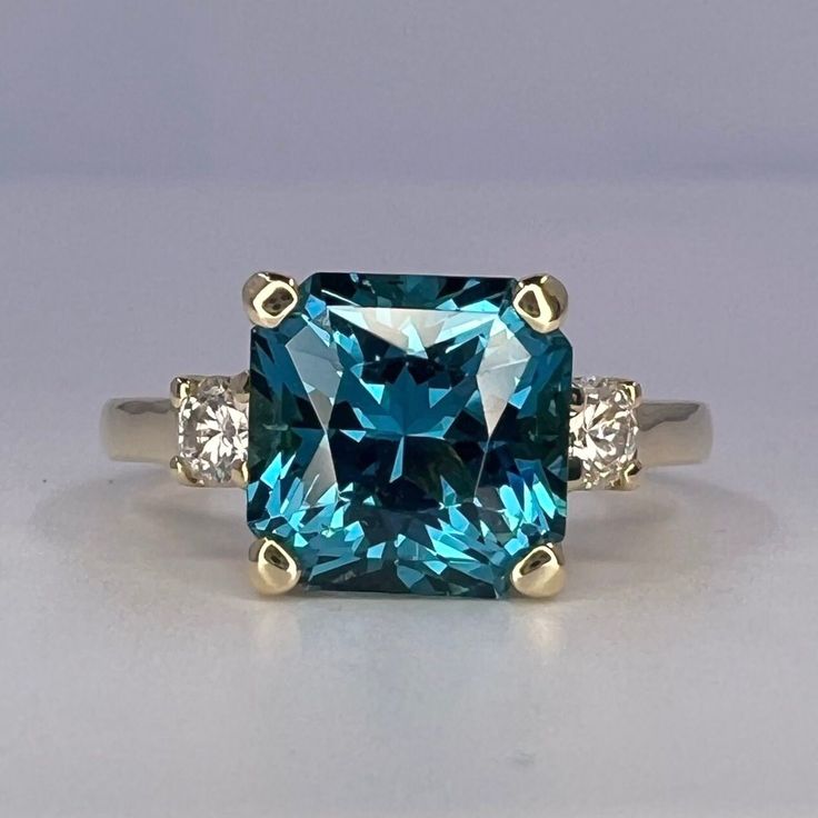 🐕 Big deals! Blue Radiant Cut Engagement Ring With Moissanite Accents in 14K White Gold, London Blue Wedding Ring, Gift For Her #6767 only at $574.00 Hurry. #6767 #SquareStone #GiftForHer #AnniversaryGift #MoissaniteRing #RadiantCut #14kWhiteGold #WeddingRing #EngagementRing #BirthdayGift Square Cut Moissanite Wedding Ring With Center Stone, Radiant Cut Topaz Ring With Prong Setting For Anniversary, Blue Radiant Cut Ring With Prong Setting, Formal Topaz Ring With Moissanite Accent Stones, Formal Blue Topaz Ring With Moissanite, Blue Princess Cut Diamond Wedding Ring, Fine Jewelry Moissanite Radiant Cut Sapphire Ring, Moissanite Topaz Ring With Round Cut Accent Stones, Gia Certified Radiant Cut Sapphire Ring Gift