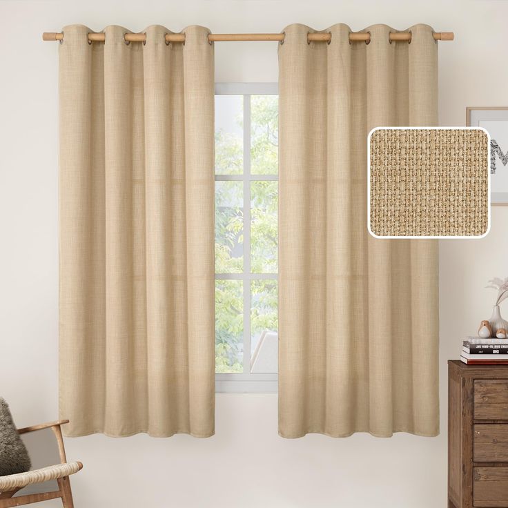 a living room with a chair and window covered in beige linens next to a wooden dresser