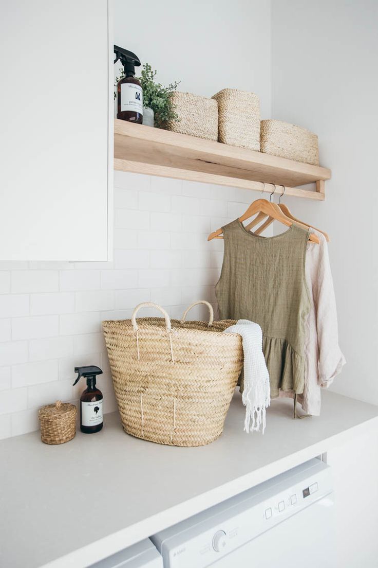 a laundry room with white walls and open shelving