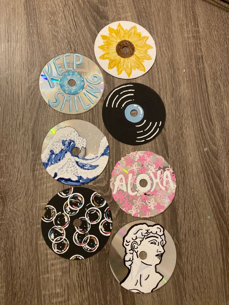 several different types of buttons sitting on top of a wooden table