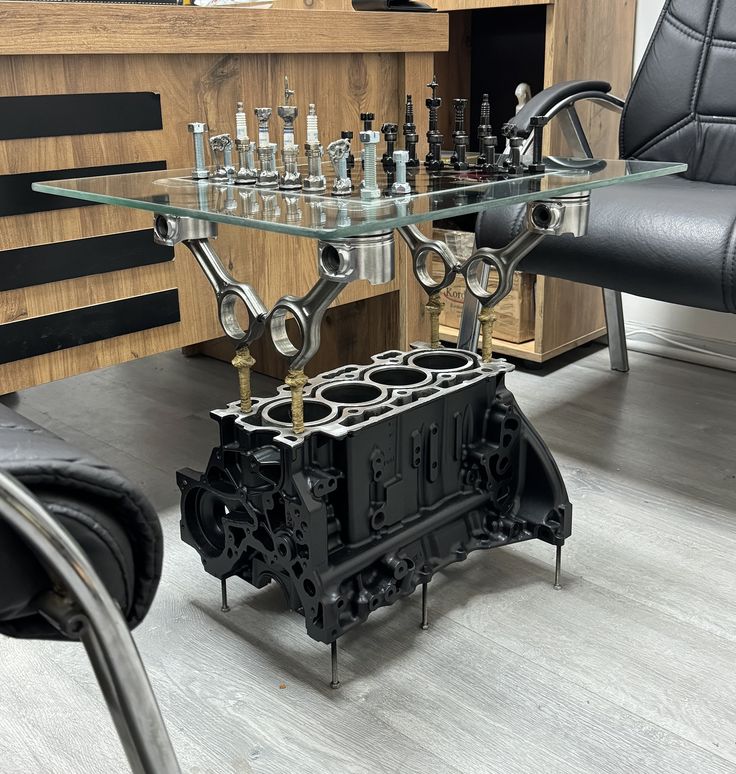 a table that has some kind of engine on it with chess pieces in the middle