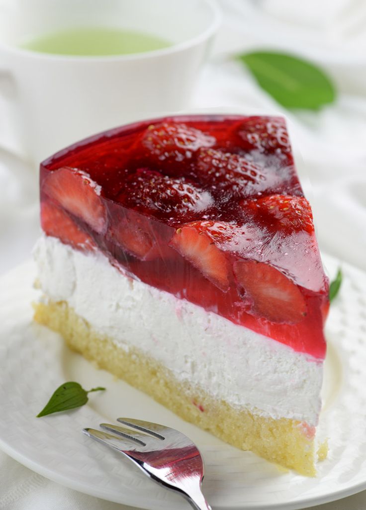 a slice of strawberry cheesecake on a plate with a fork