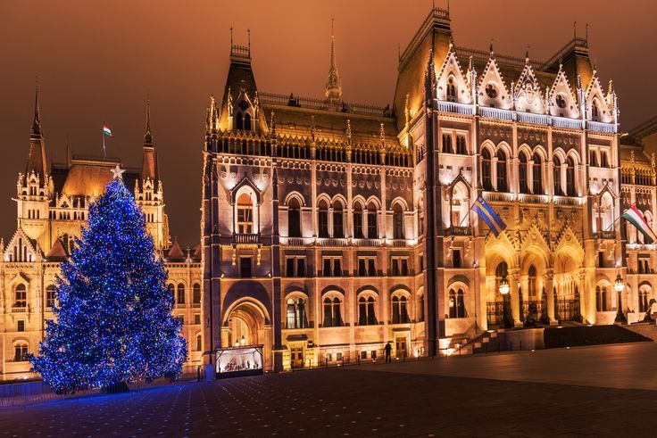 a large building with a christmas tree in front of it