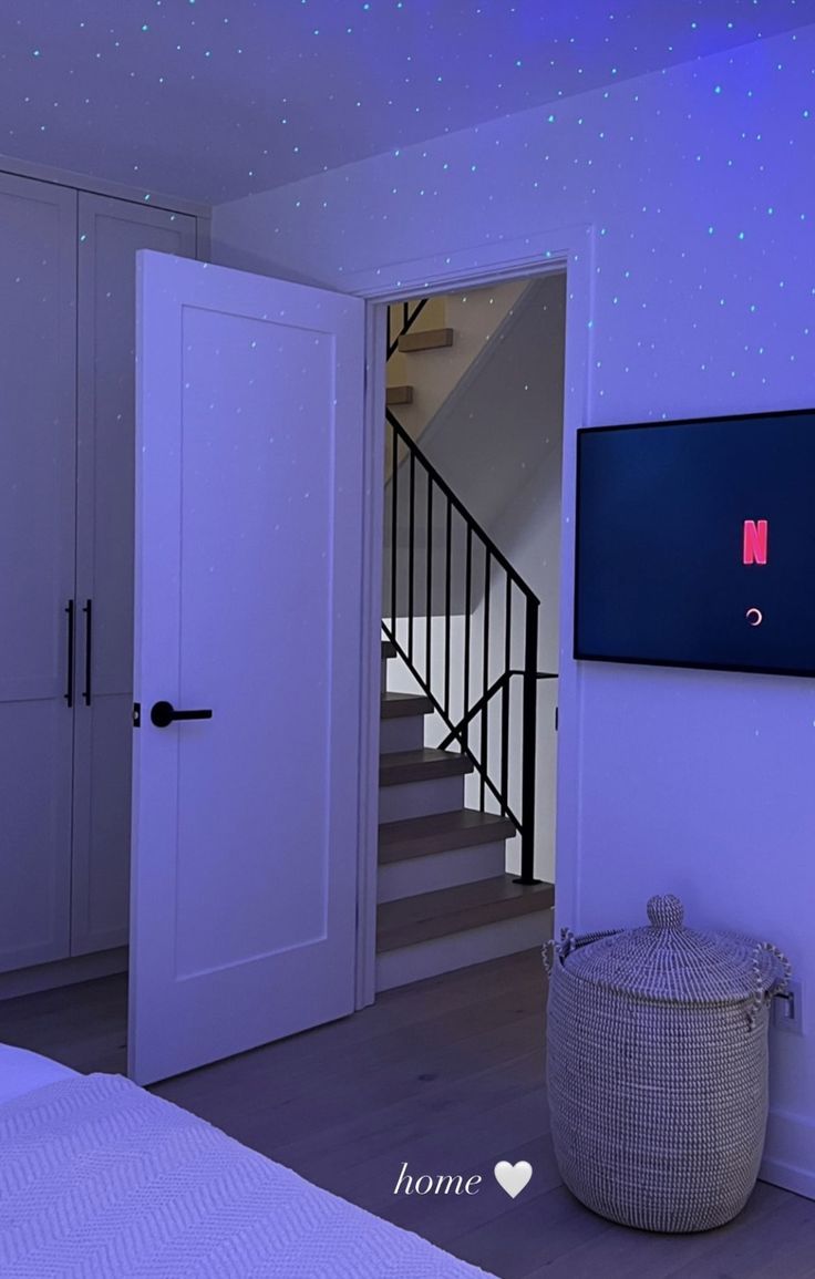 a bedroom with white walls and blue lighting