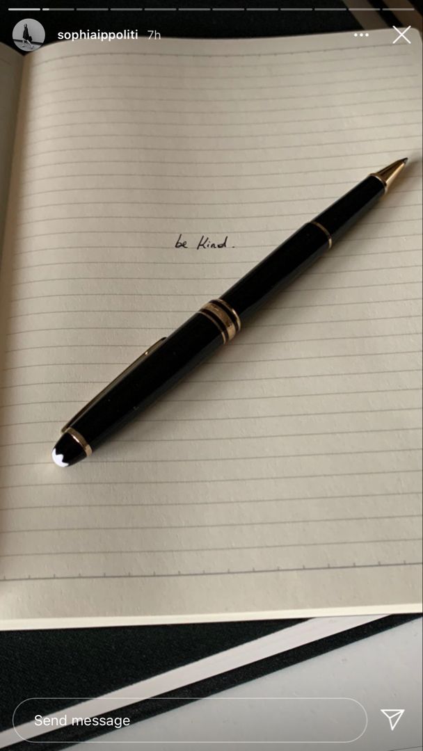 a pen sitting on top of a notepad next to an open notebook with writing