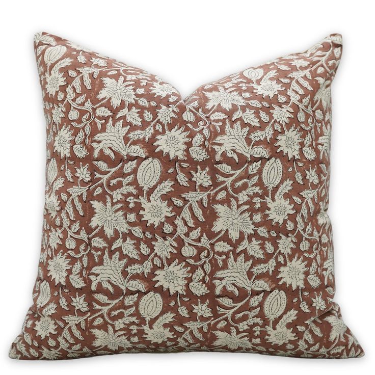 a brown and white pillow on a white background