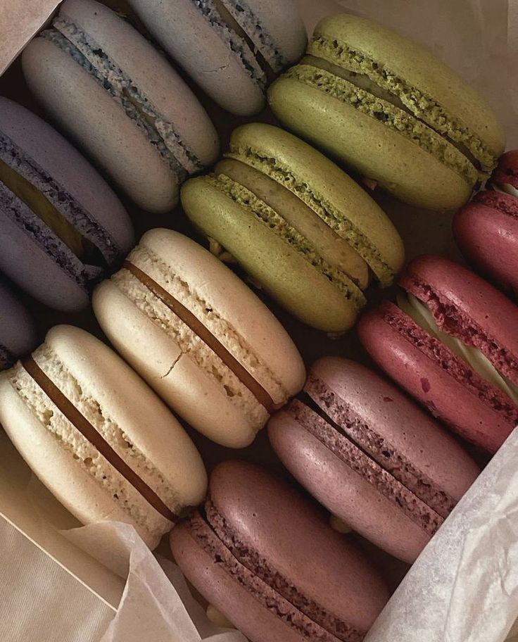 a box filled with lots of different colored macaroons