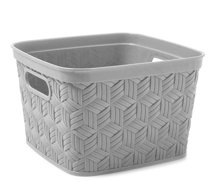 a white plastic basket with a handle on the bottom and handles in grey weave pattern