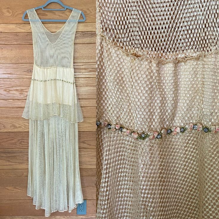 two dresses hanging up against a wooden wall