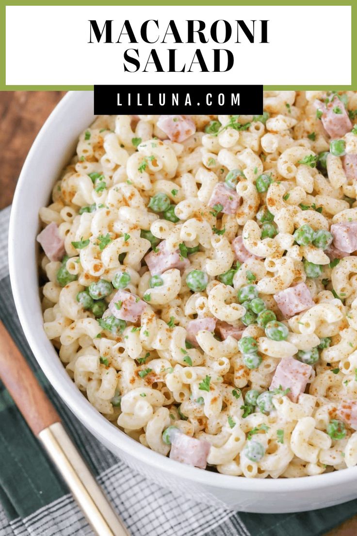 macaroni salad with peas and ham in a white bowl next to chopsticks