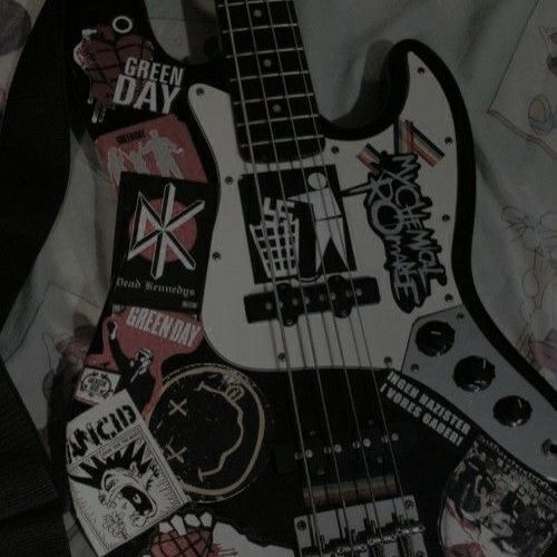 a black and white guitar with stickers on it