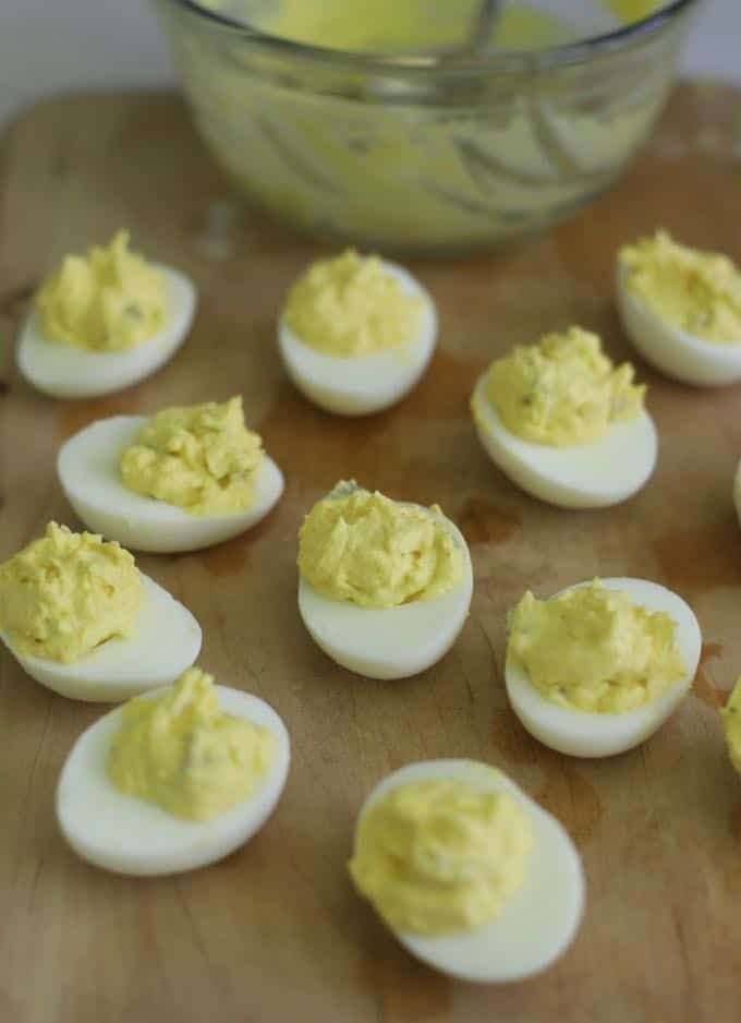 deviled eggs are arranged on a cutting board