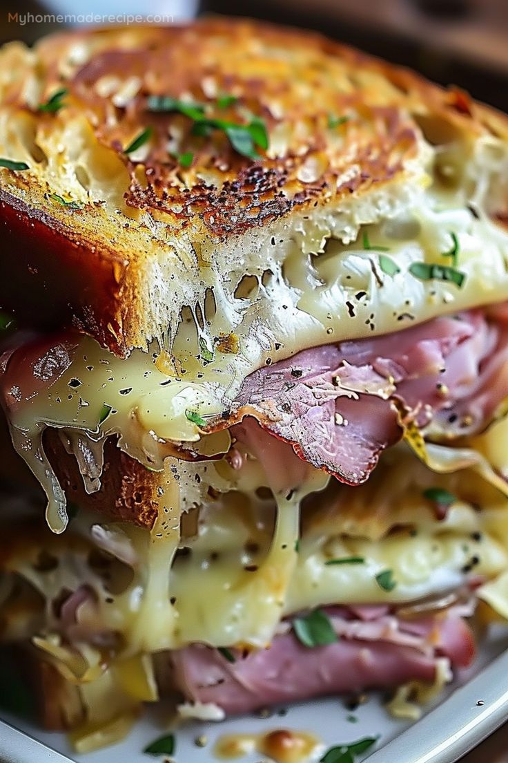 a close up of a sandwich on a plate with cheese and meat in the middle