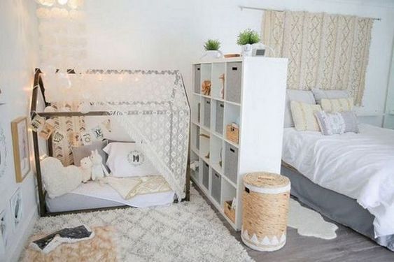 a bedroom with two beds and a book shelf in the corner next to each other