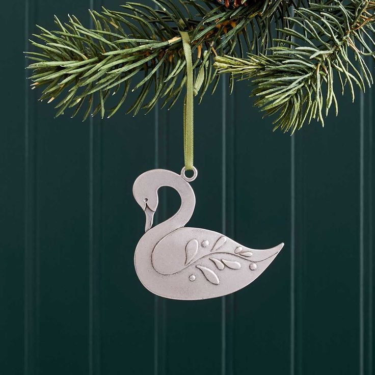 a metal ornament hanging from a christmas tree