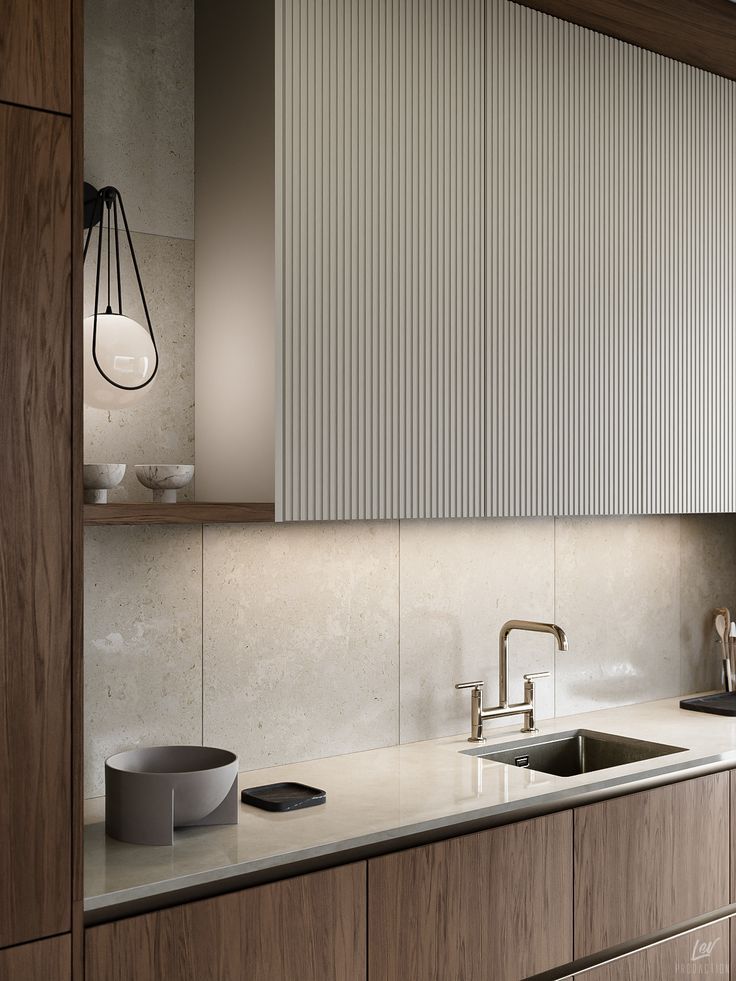 a modern kitchen with wooden cabinets and marble counter tops, along with a stainless steel sink