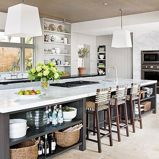 a kitchen with lots of counter space and stools next to an island in the middle