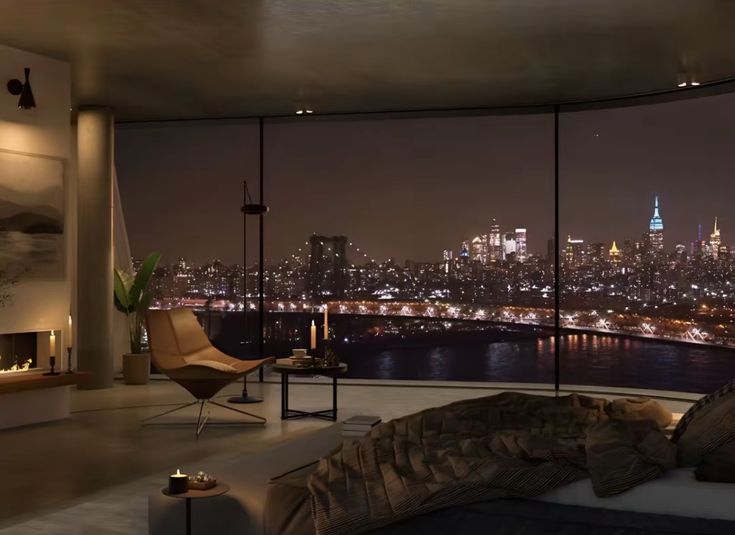 a living room with a view of the city lights at night from it's windows