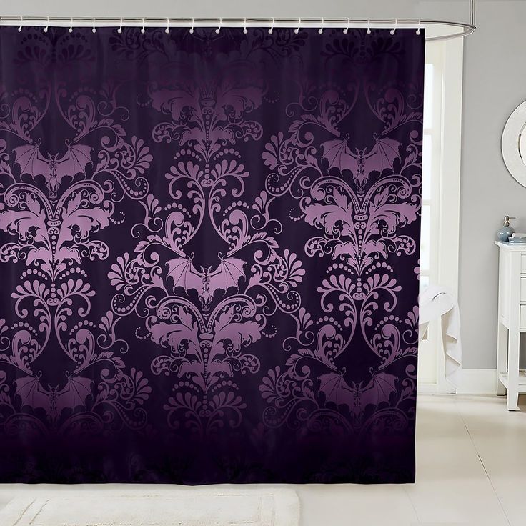 a purple shower curtain in a bathroom