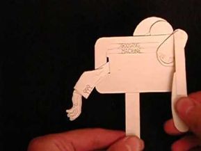 someone is holding up a paper cut out of a horse with its head and tail