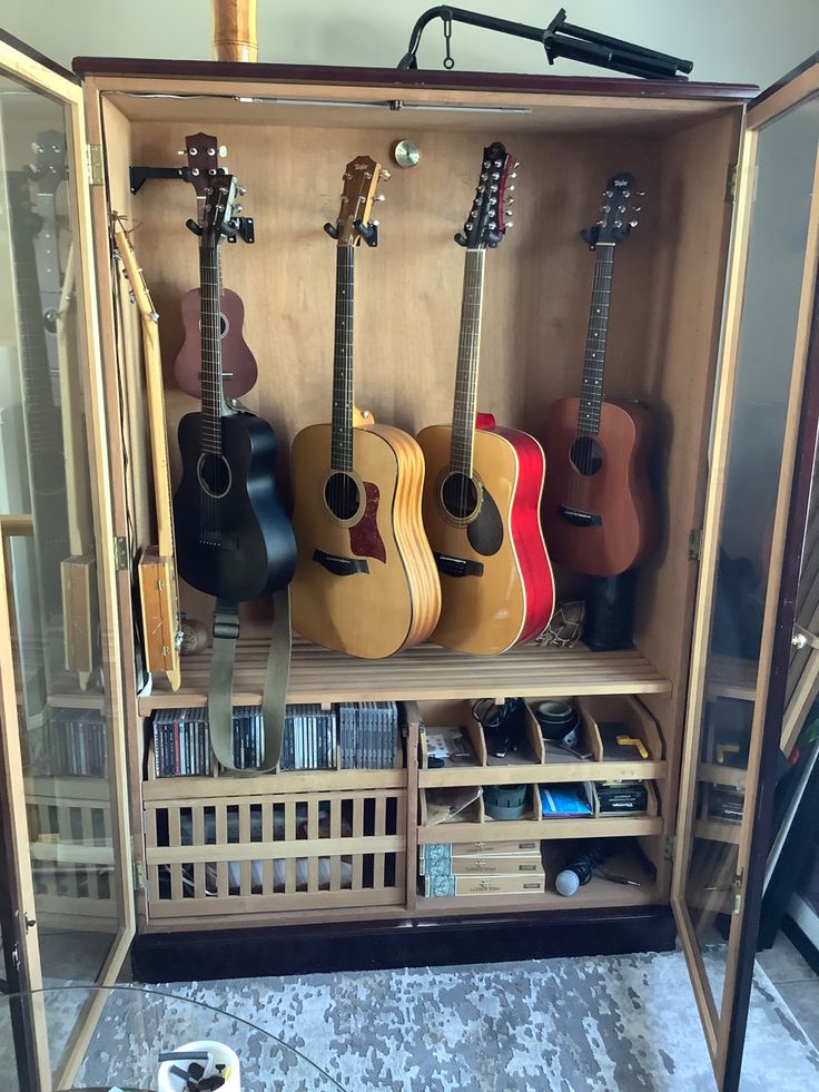 a display case with guitars and other musical instruments