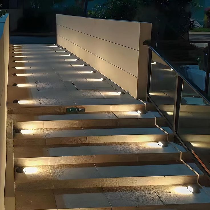 some steps with lights on them and one light is on the ground next to it