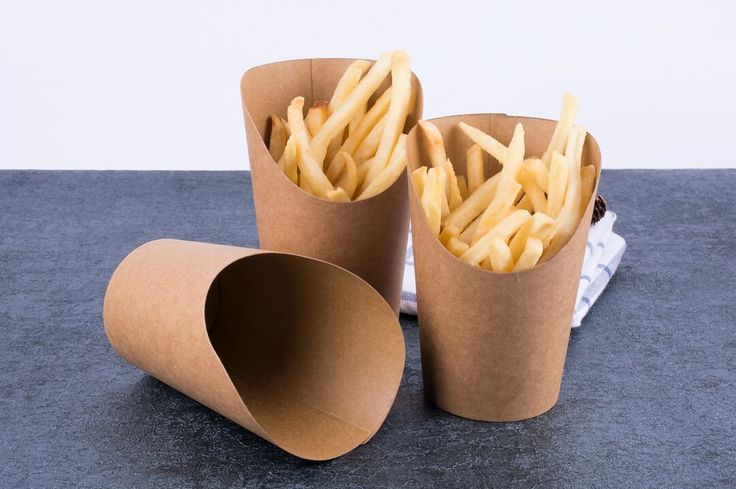 two brown paper cups filled with french fries