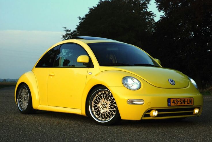 a yellow car is parked on the street