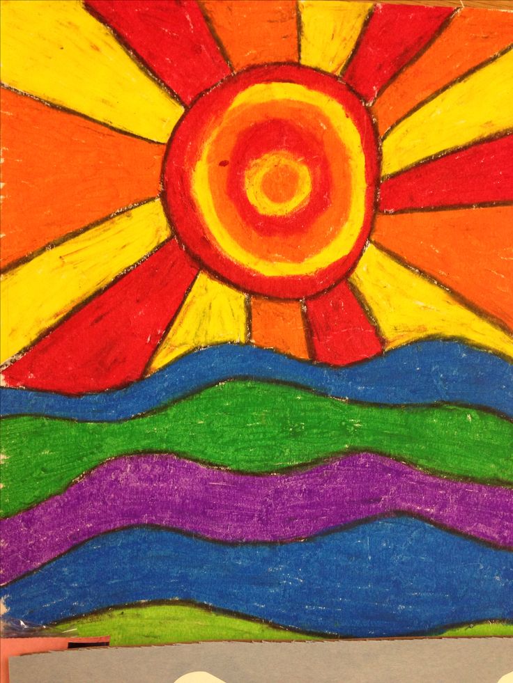 an art project made with colored crayons and chalk pastel on paper, depicting the sun rising over mountains