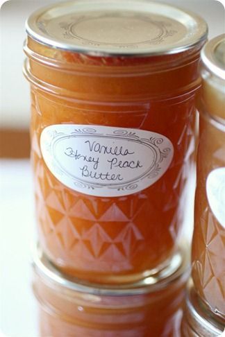 two jars filled with honey sitting on top of a table