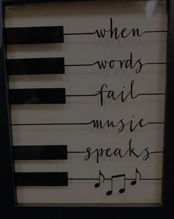 there is a sign that says when words fail music speaks and piano keys are drawn on it