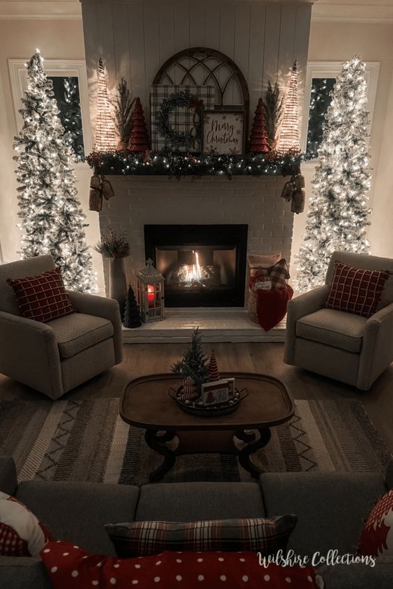 a living room filled with furniture and a fire place covered in christmas decorations on the mantle