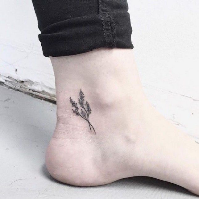 a small flower tattoo on the ankle