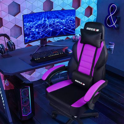 a gaming chair sitting in front of a computer desk with a keyboard and mouse on it