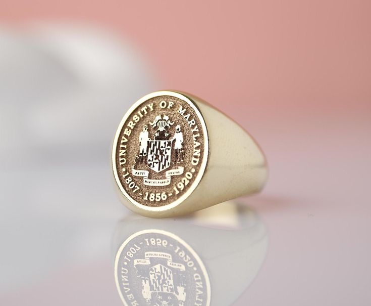 Introducing our stunning 14k Solid Gold custom college class signet ring! This exquisite piece is the perfect way to commemorate your academic achievement in style. Crafted with top-quality materials, this unique ring can be tailored to feature your graduation year or college insignia for a personalized touch. Whether as a gift for yourself or a loved one, this ring is sure to be cherished for years to come. Make a statement with this timeless keepsake that celebrates your academic journey in a Gold Jewelry With Engraved Logo For Formal Occasions, Graduation Rings College, Class Rings College, Graduation Rings, College Classes, Gold Signet Ring, Jewelry Workshop, Personalized Products, Signet Ring