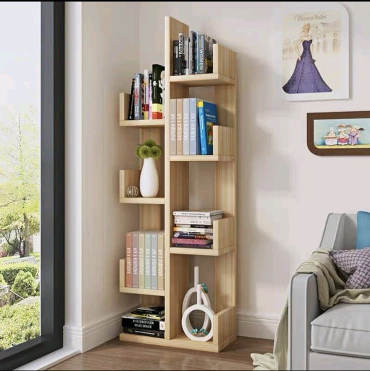 a living room filled with furniture and a book shelf next to a sliding glass door