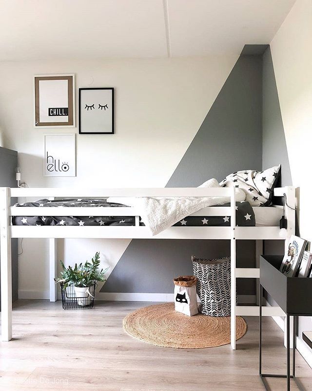 a white loft bed sitting on top of a hard wood floor