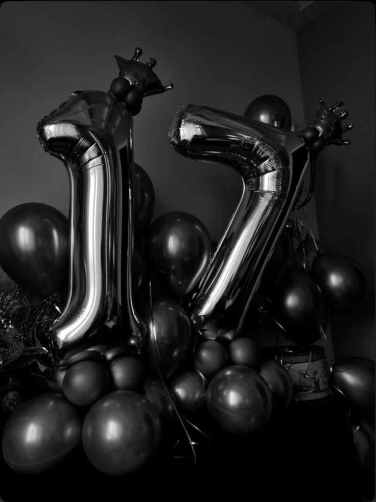 black and white photograph of balloons in the shape of the letter k on top of a table