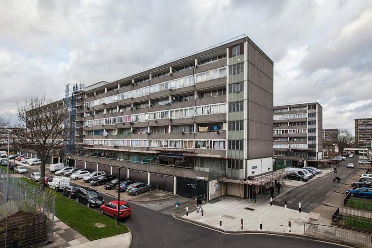 an apartment building with cars parked in front of it