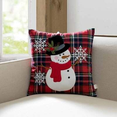 a snowman pillow sitting on top of a couch