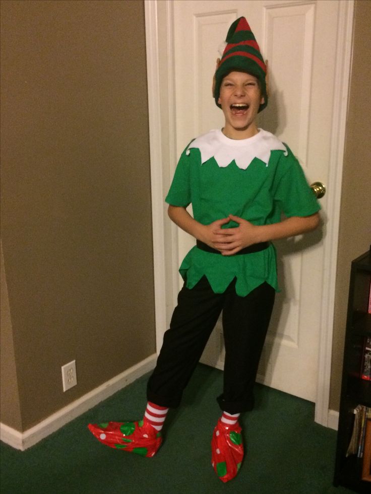 a young boy dressed in an elf costume