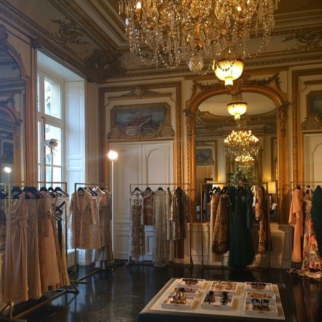 a room filled with lots of dresses and chandeliers