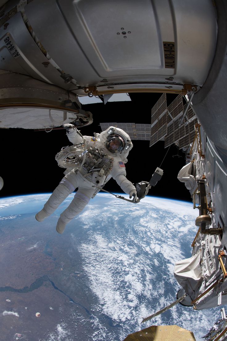 an astronaut floating in the air above earth