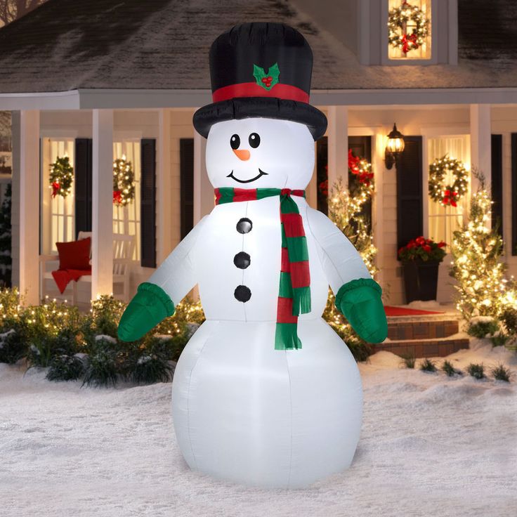 a large inflatable snowman with a hat and scarf on it's head