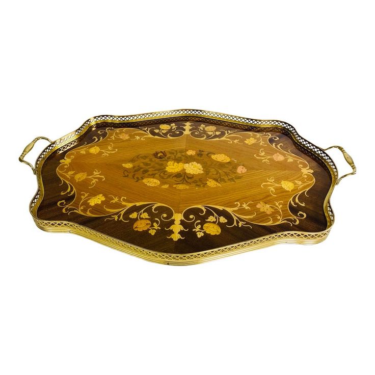 an ornately decorated serving tray with gold trimmings and flowers on the edges