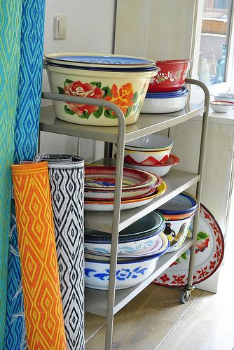 a metal rack with bowls and plates on it