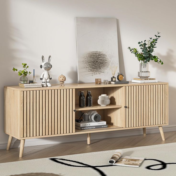 a wooden cabinet with shelves and plants on top in a room next to a rug