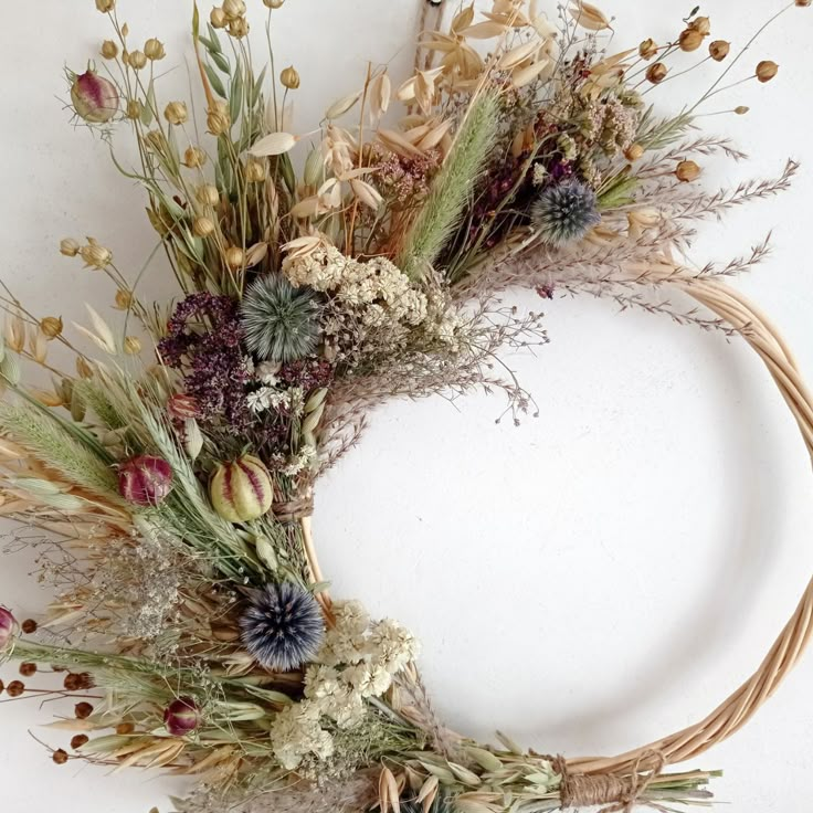 a wreath made out of dried flowers and grasses