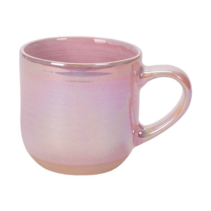 a pink coffee cup sitting on top of a white table