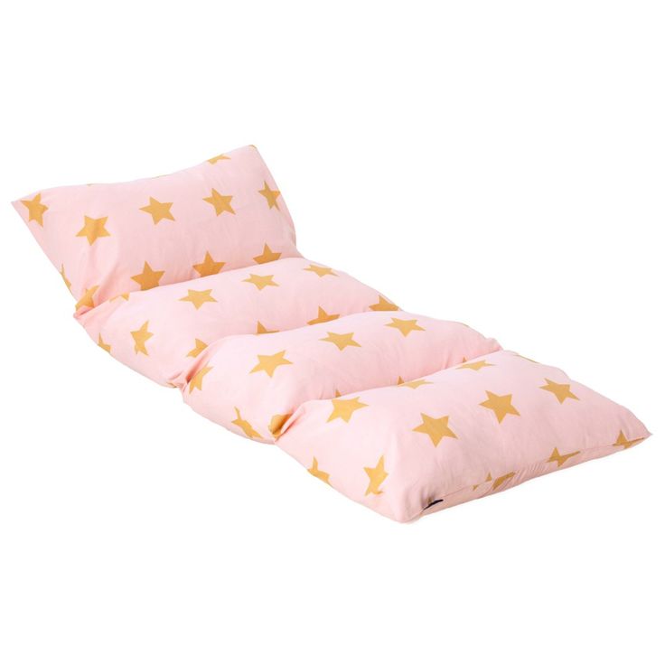 a pink pillow with gold stars on it and a light pink pillow underneath the pillow